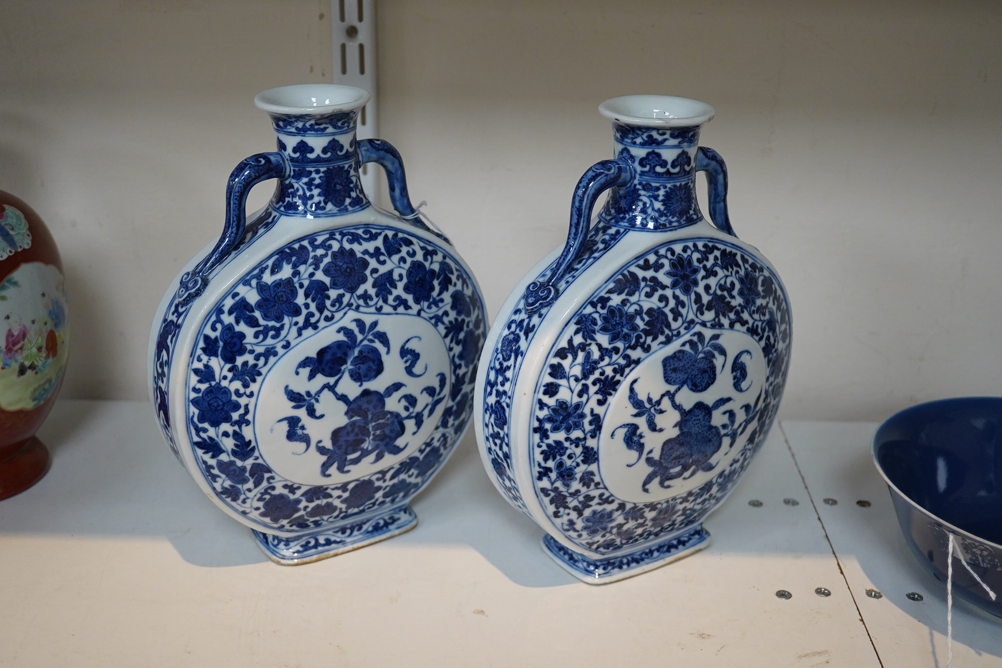 A near pair of Chinese blue and white moonflasks, bianhu, Daoguang seal marks and of the period (1821-50)